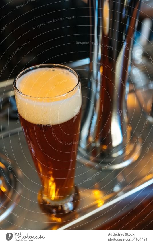 Glass of dark beer on table pub glass alcohol bar drink barman liquid foam service beverage craft refreshment party product ales pint cold restaurant casual
