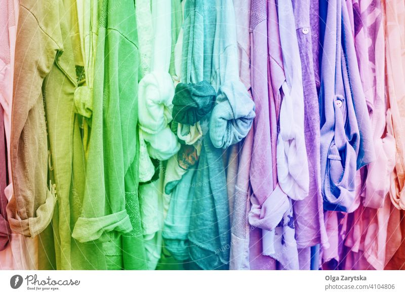 Rainbow background with clothes. casual shop store jersey woman fashion design abstract retail pink blue clothing collection garment rainbow sale textile wear