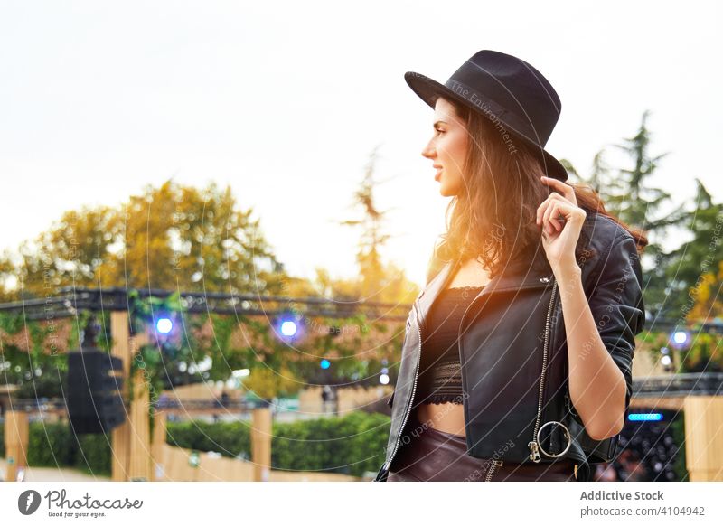 Woman looking away in festive park woman festival romantic celebration holiday vacation event charming fashion long haired entertainment joy enjoying fun