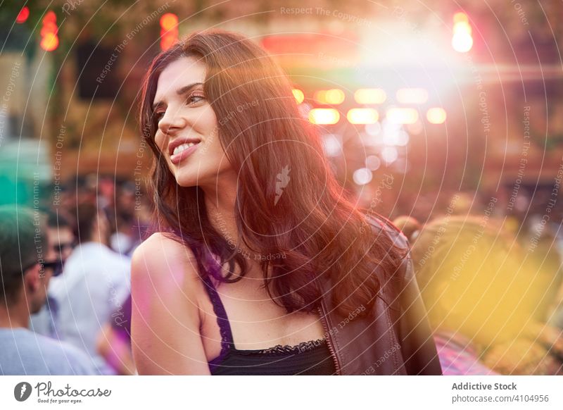 Woman looking away in festive park woman festival romantic celebration holiday vacation event charming fashion long haired entertainment joy enjoying fun
