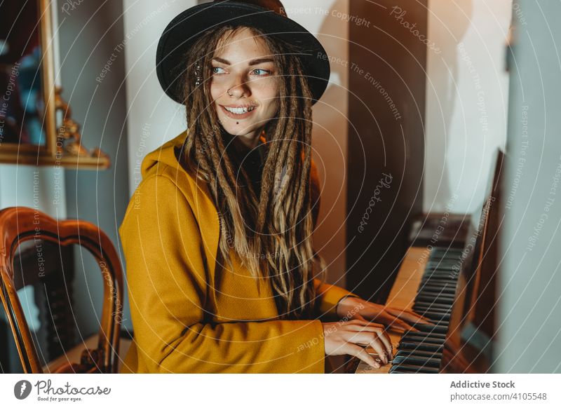 Hipster millennial woman playing piano dreadlocks hipster music stylish sit female focused concentrated practicing musician instrument art pianist melody key
