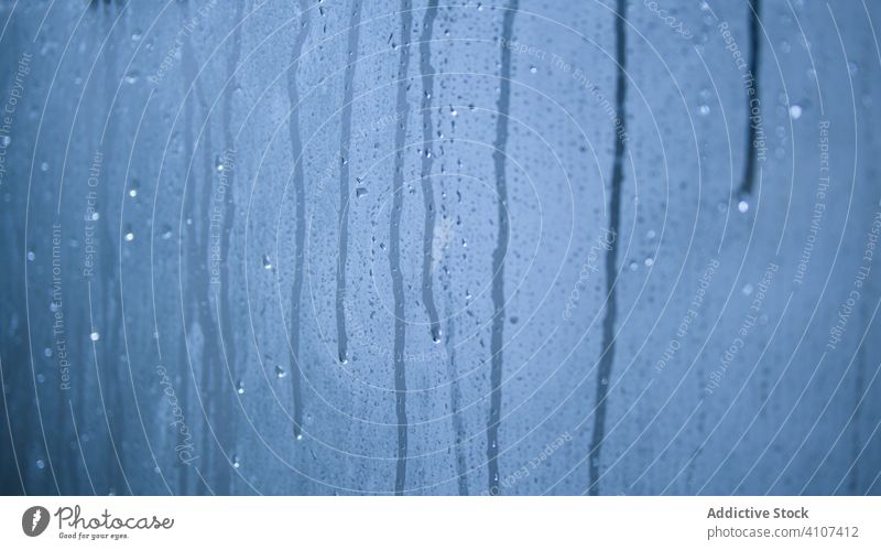 Drops of water on blue background drop glass surface rain splash fresh wet liquid clean abstract aqua beauty spray purity condensation weather texture shower