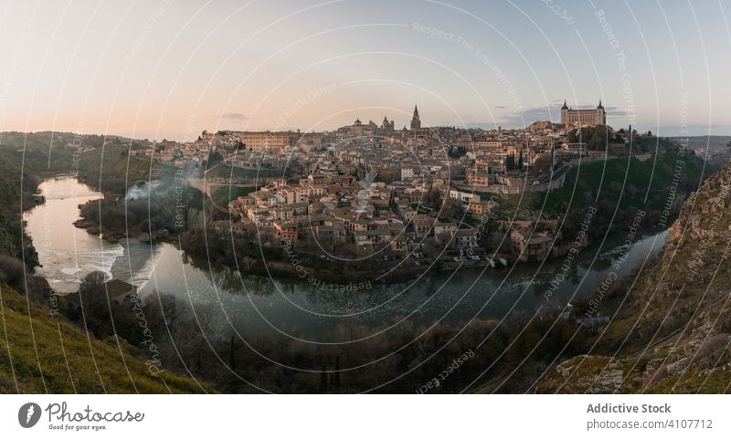 Old town across river at sunset time architecture old medieval cityscape travel tourism building scenic hill water destination picturesque spain toledo