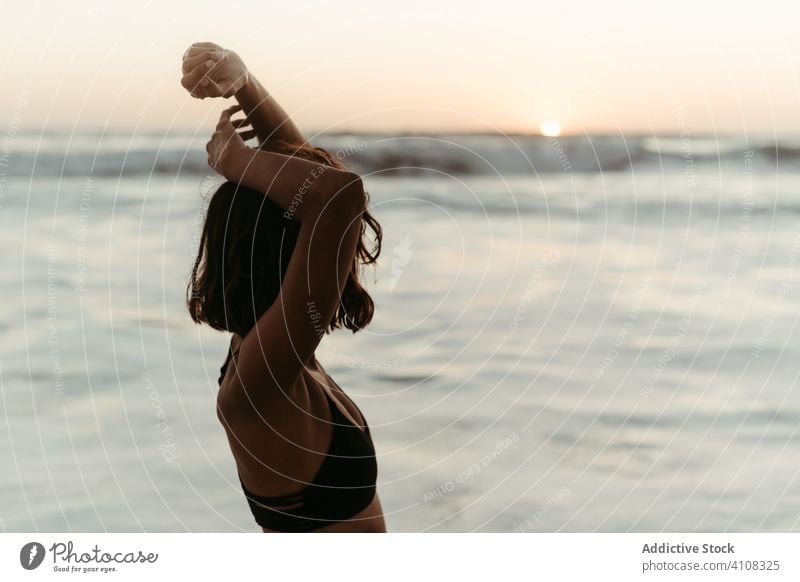 Faceless woman enjoying sea in summer contemplate seascape sunset relax beach vacation female water slim rest lifestyle travel carefree freedom ocean nature