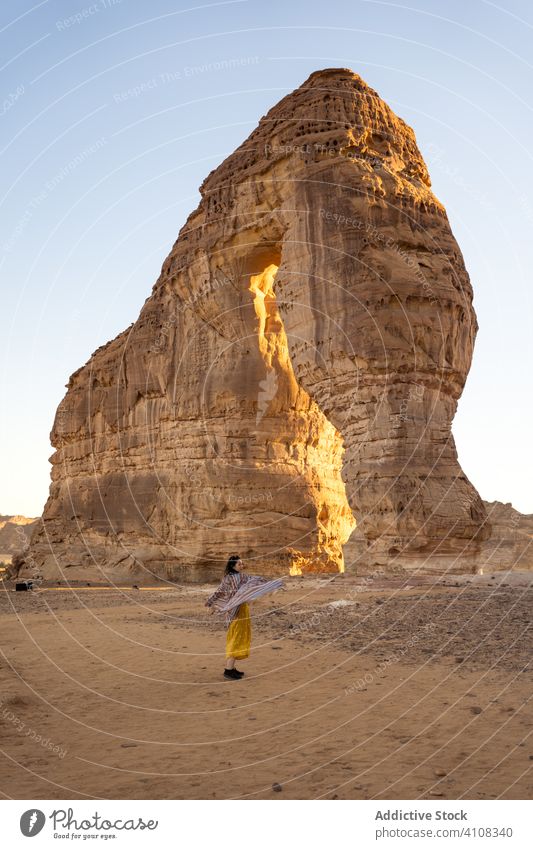 Anonymous female tourist visiting sandstone rocks in country woman enjoy sightseeing nature adventure cliff destination freedom tourism journey formation