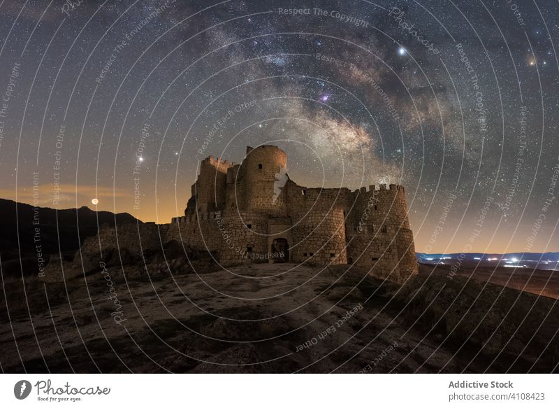 Scenic landscape of medieval castle in starry night abandoned ancient palace sky colorful mountain ruined remain architecture building tower travel tourism