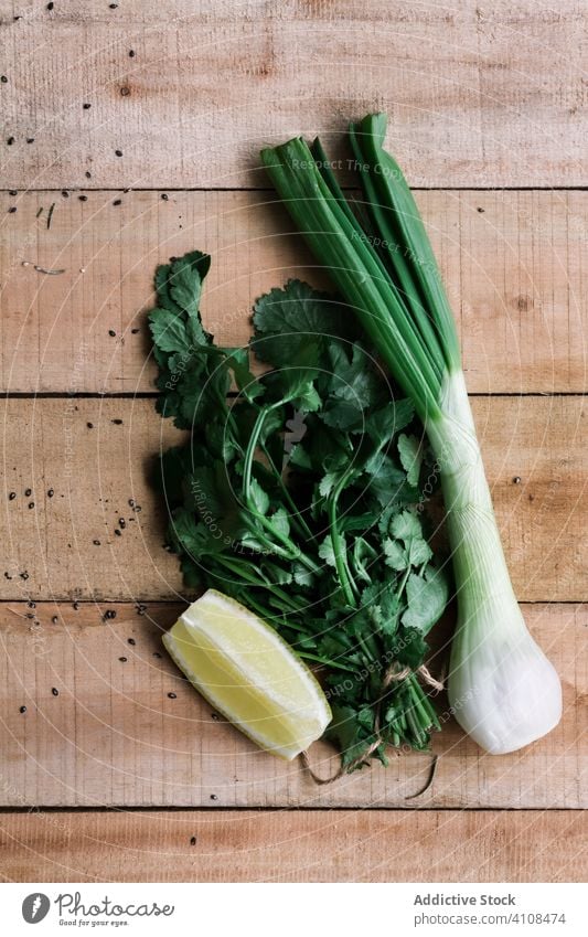 Fresh green onion and parsley with lemon on table fresh raw bunch wooden ingredient food vegetable meal appetizer healthy nutrition cuisine gourmet recipe
