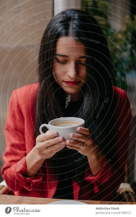 Woman drinking coffee in cafe woman breakfast table cup newspaper morning relax rest cafeteria casual lifestyle modern young beverage food hot indoors blur