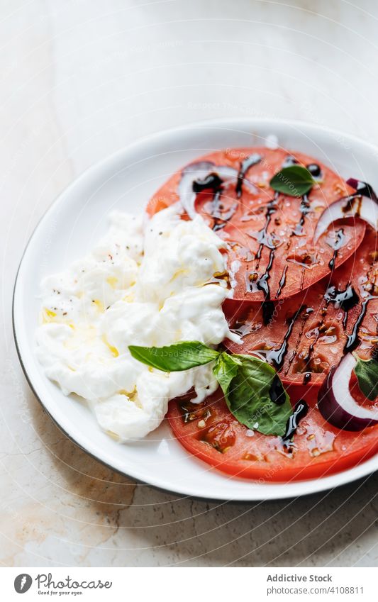 Tomatoes onion and sour cream salad in plate tomatoes green tasty dish gourmet delicious food cuisine fresh meal lunch nutrition appetizing portion sauce