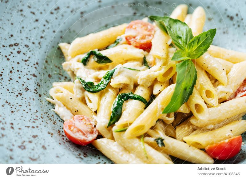 Fresh pasta with vegetables and sauce dish cherry tomatoes greenery haute cuisine restaurant plate italian basil bowl herb culinary organic classic tasty meal