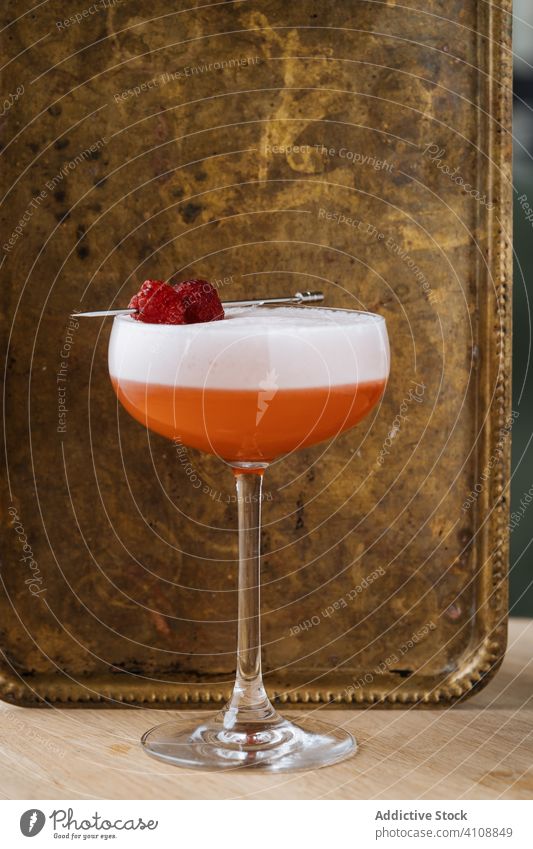 Clover Club cocktail in restaurant bar spoon strainer modern glass alcohol style clover club beverage drink gin raspberry foam red colorful decoration table