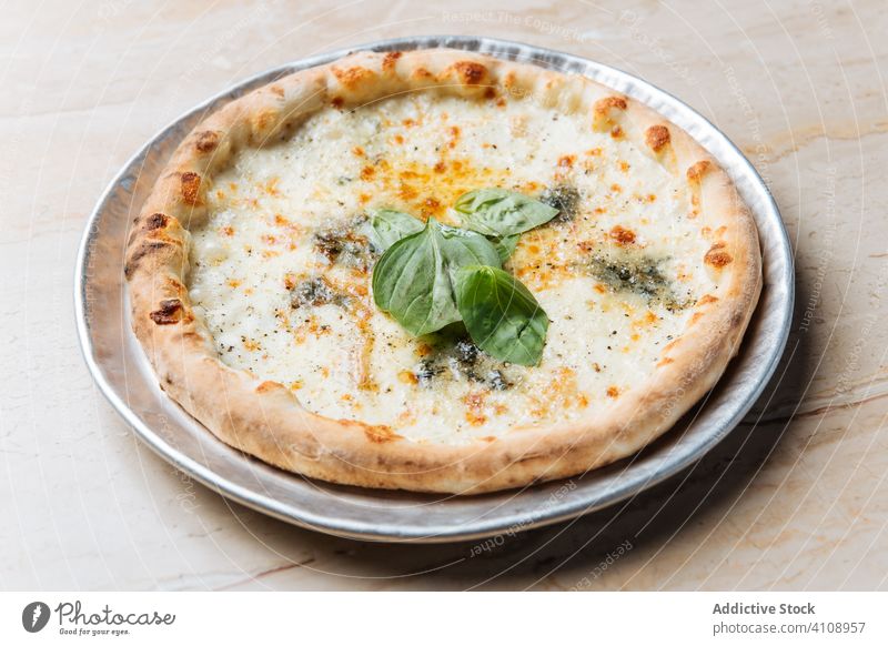 Fresh pizza with cheese in restaurant dish food meal tasty tradition italian lunch delicious cuisine round yummy fresh herb plate portion crust appetizing