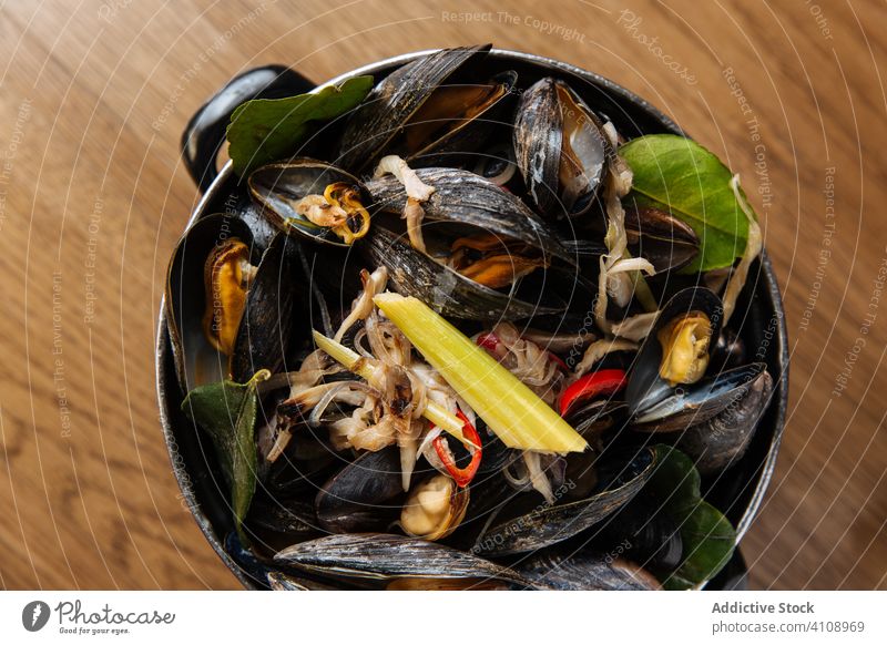Black shellfish with vegetables in bowl delicious seafood mollusk delicacy clam celery mediterranean mussel green black marine culinary meal organic ingredient