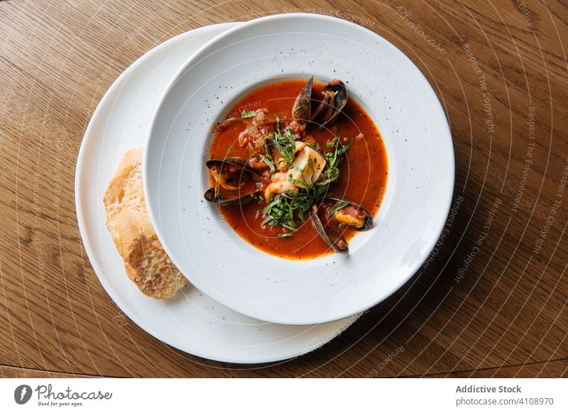Tomato soup with mussels and toast on side seafood tomato cuisine spicy organic exquisite mediterranean clam shellfish broth green bread seasoning delicacy stew