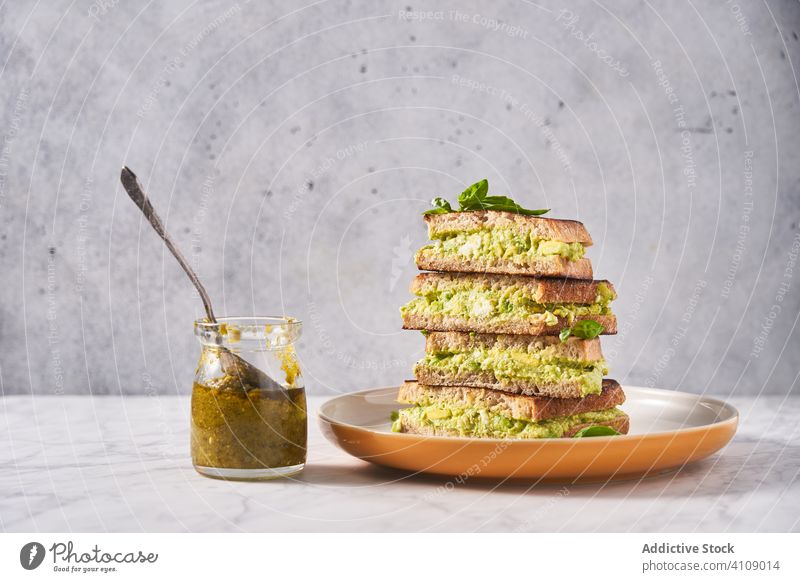 Healthy sandwiches with guacamole and mint dish plate avicado pesto sauce jar table stack spoon healthy herb smoothie nutrition organic natural puree vegetable