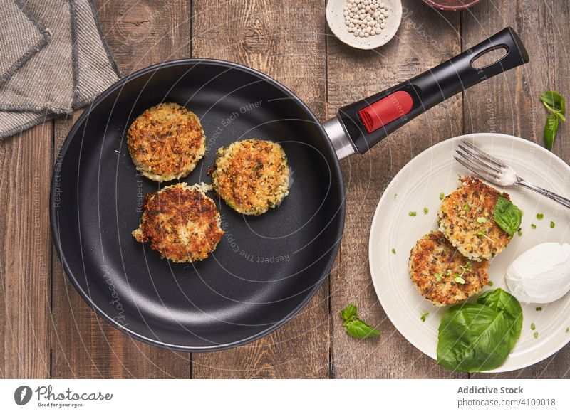 Tasty cutlets in pan and plate meatball dish chop wooden table basil mozzarella spice fried roasted restaurant herb sauce stylish food grill professional