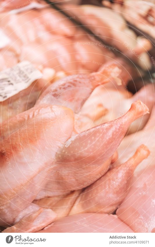Raw chicken in freezer in shop raw cold fresh sell grocery poultry meat product fridge refrigerator supermarket hypermarket cuisine store trade retail food