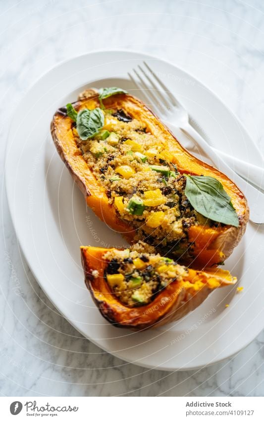 Stuffed squash with quinoa and vegetables on white plate pumpkin stuffed food vegan vegetarian filling cooking baked half served ingredient recipe stuffing