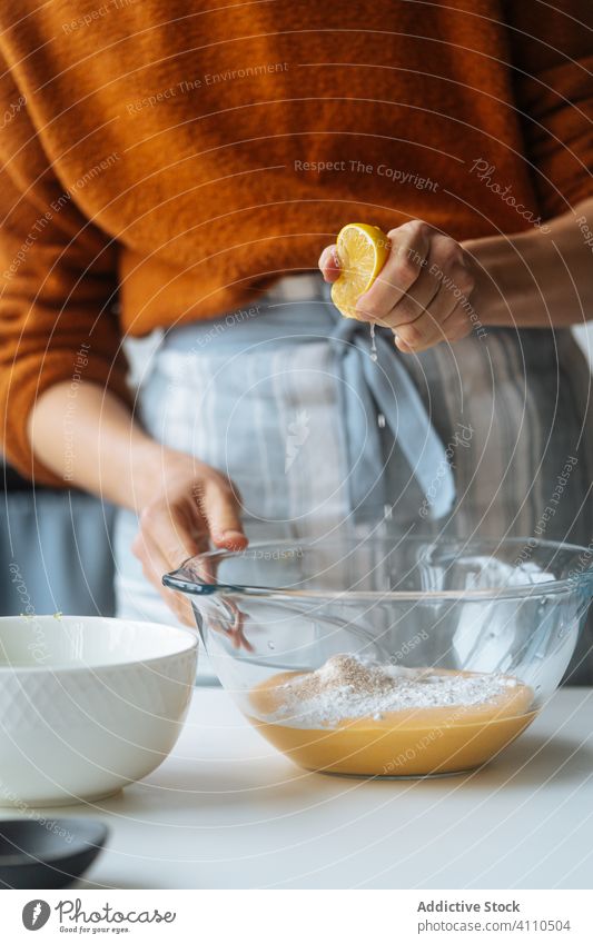 Woman squeezing lemon into bowl at table cook citrus puree juice mixture orange glass cuisine healthy kitchen food vegan lunch homemade dinner cream ingredient