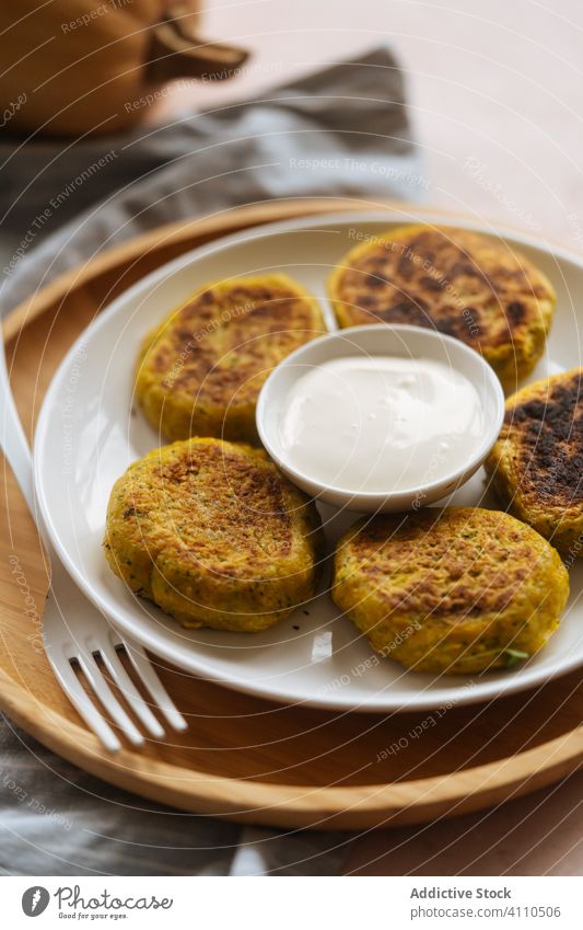 Delicious vegetable cutlets with sour cream on table pumpkin traditional fried golden roasted cuisine dish delicious gourmet plate meal food recipe snack rustic
