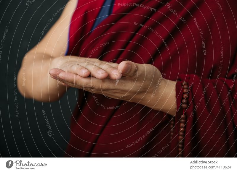 Buddhist monk with mudra hands gesture buddhist pray religion symbol traditional tibet red culture spirituality faith belief asia authentic holy sacred mantra