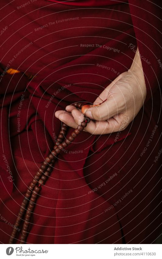 Buddhist prayer with rosary beads buddhist symbol traditional religion tibet monk red culture spirituality faith belief asia authentic holy sacred mantra