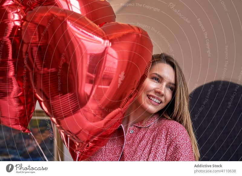 Happy adult woman with gifts celebrating Saint Valentines Day valentine happy balloon romantic heart excited love celebrate event holiday present joy pajamas