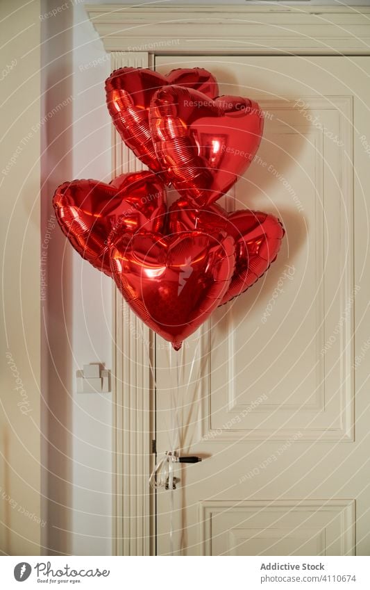 Red glossy balloons in bedroom gift romantic valentine heart symbol surprise concept propose present engagement love elegant holiday decor empty event shape