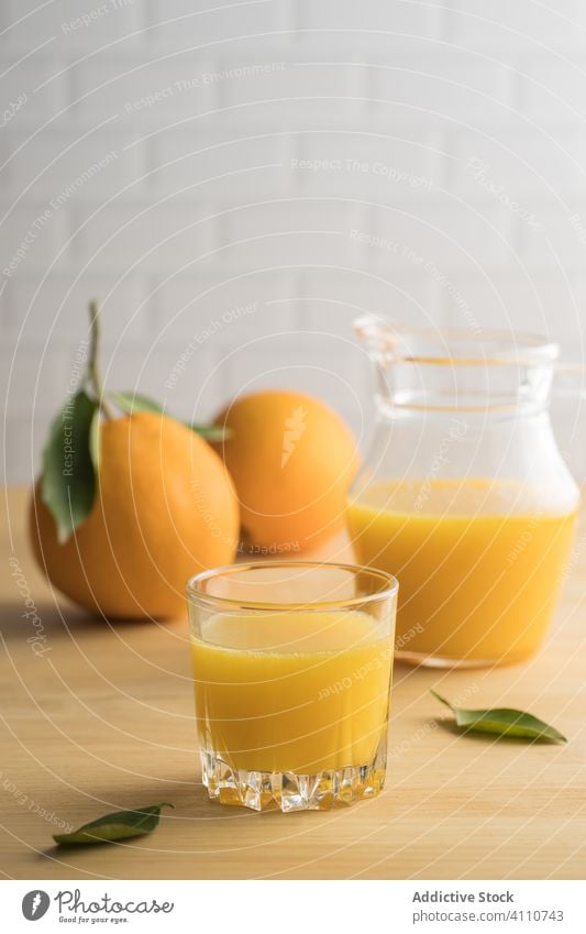 Orange juice in glass on table orange fresh vegan jar kitchen summer vitamin fruit citrus exotic ripe healthy drink beverage natural organic vegetarian diet
