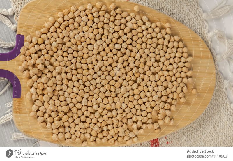 Heap of chickpea on wooden board heap kitchen cutting board raw natural food organic ingredient pile fresh healthy nutrition vegetarian vegan bunch edible diet