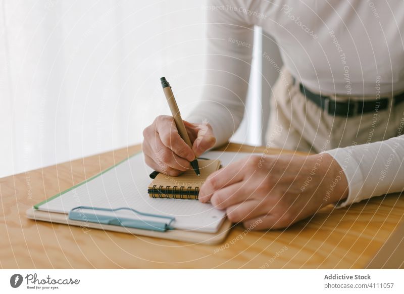 Crop woman taking notes at wooden desk notepad business take note write workplace occupation table creative copy space workspace entrepreneur diary reminder