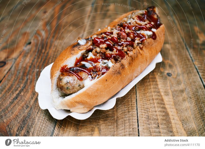 Delicious hot dog on wooden table sausage tasty appetizing fast food delicious meal tradition ketchup sauce nutrition gourmet cook cuisine snack bread eat meat