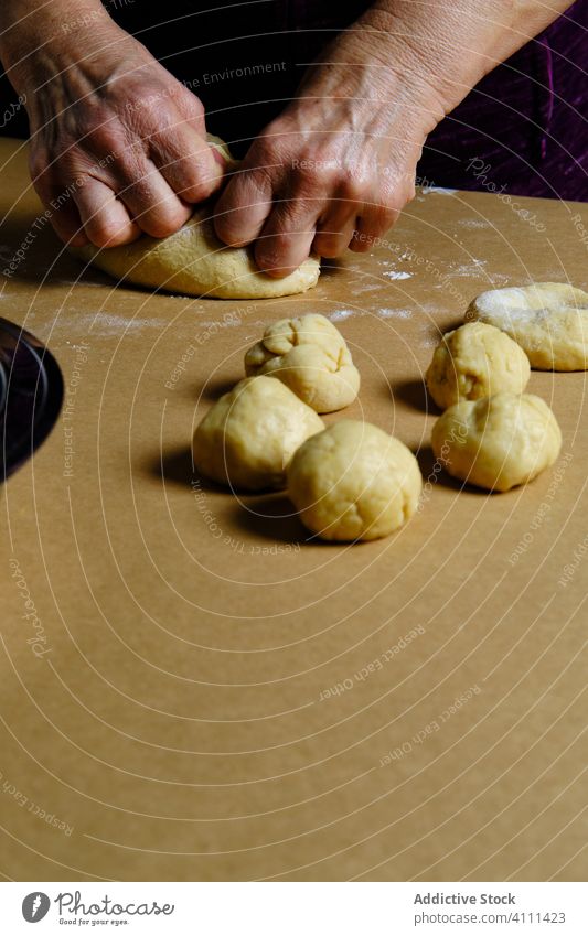 Crop woman rolling balls from dough table pastry cook home kitchen soft female doughnut donut prepare food ingredient recipe cuisine fresh homemade raw culinary