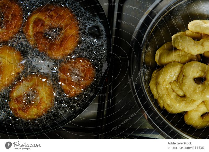 Yummy donuts frying in hot oil stove bubble cook skimmer cuisine food fresh delicious tasty meal gourmet prepare tradition kitchen culinary nutrition recipe