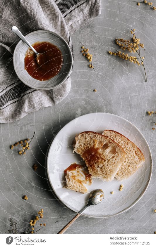 Tasty bread with jam for breakfast brioche food tasty delicious fresh sweet dessert homemade pastry meal spoon serve dish plate bun table yummy cuisine spread