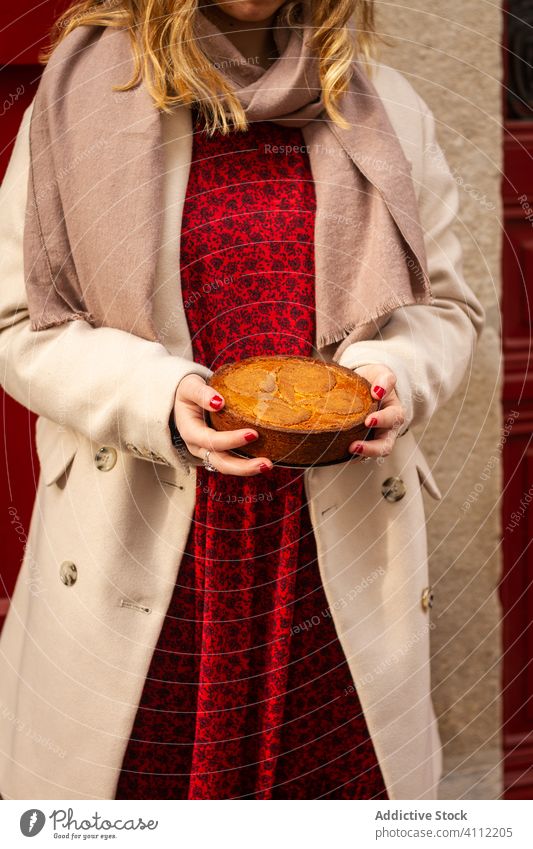 Crop woman with tasty pie carry coat dessert food delicious style elegant pastry gourmet cuisine snack meal natural nutrition cake culinary sweet treat