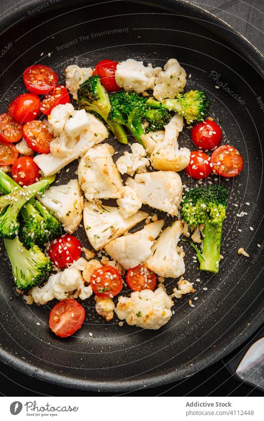 Tomatoes frying with cauliflower and broccoli tomato pan kitchen cook vegetable vegan food meal delicious fresh nutrition tasty healthy organic ingredient