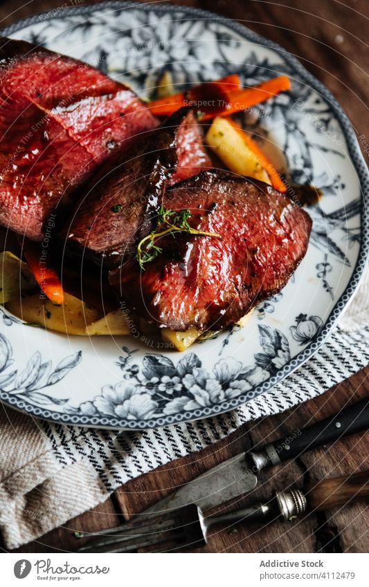 Roast beef with vegetables served on plate meat roast tenderloin grill food gourmet delicious rare wine meal dinner cuisine tasty dish cook nutrition herb