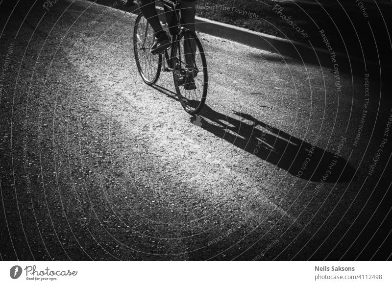 Shadow of man riding bicycle on street. Action activity asphalt balance bicycling bike adult city cute exercise fun joy leisure lifestyle little nature outdoor
