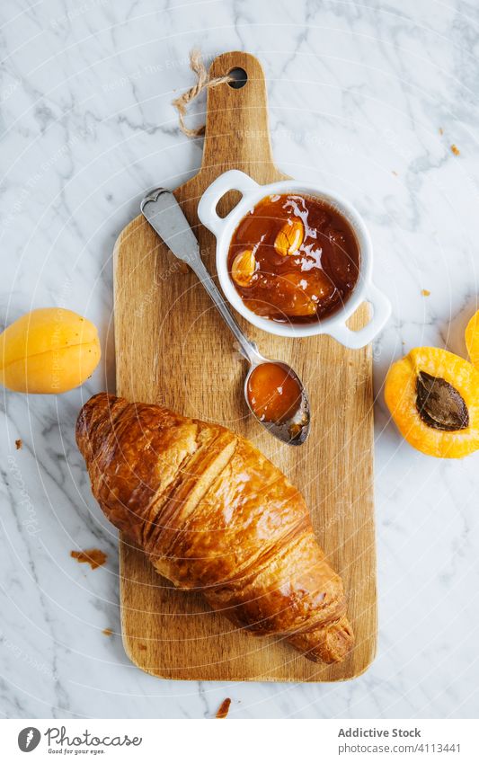Croissant and apricot jam on wooden board croissant pastry breakfast bake fresh natural morning food serve delicious tasty meal tradition gourmet nutrition