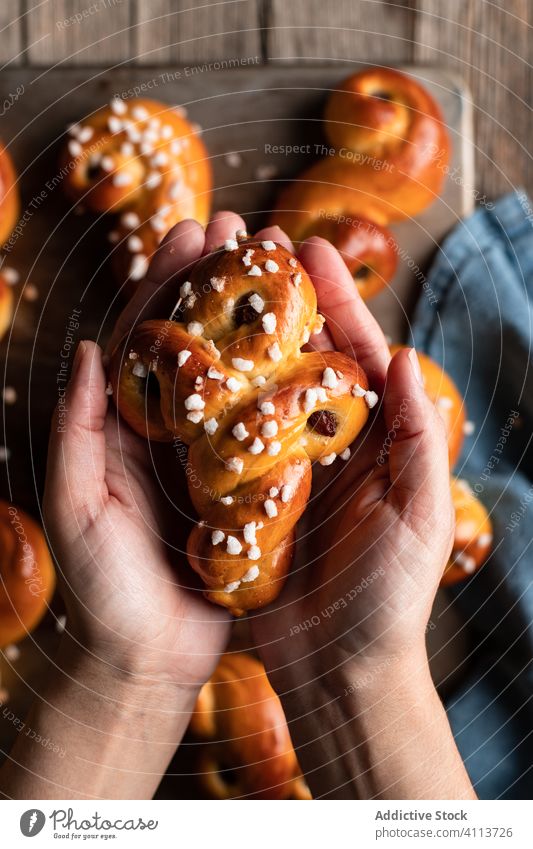 Person holding delicious homemade buns food bake hand person tasty pastry sweet saffron tradition yummy fresh nutrition appetizing eat cook culinary winter