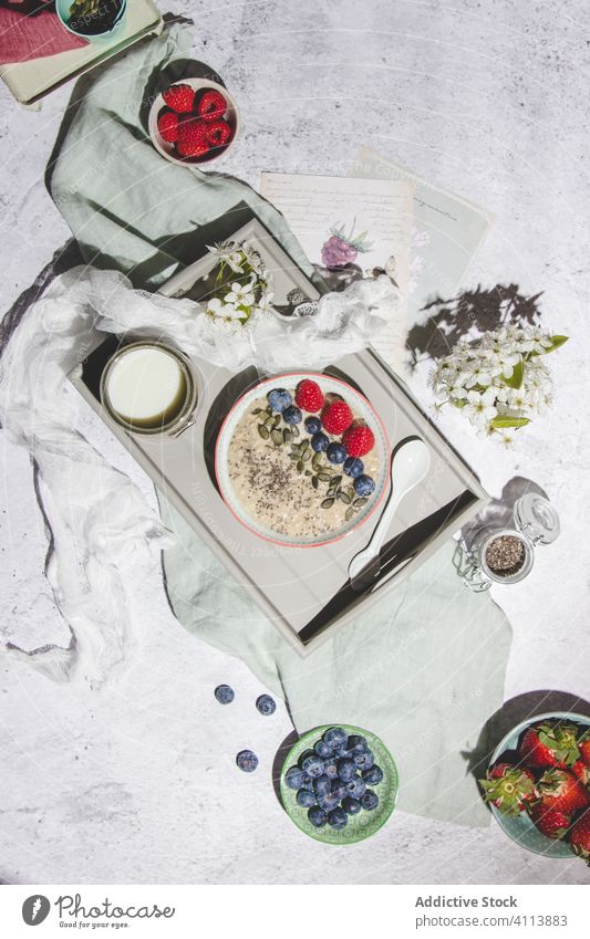 Healthy breakfast with porridge and berries berry healthy tray morning food serve fresh natural oat blueberry raspberry strawberry oatmeal flower composition