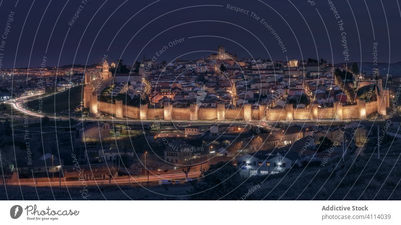 Picturesque landscape of old town at night viewpoint castle wall ancient light fortress illuminate road avila architecture city evening medieval tourism