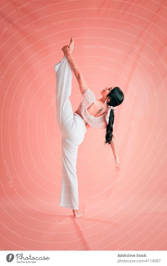 Elegant woman doing splits during dance grace concept young slim ballet elegant outfit female ballerina perform barefoot style trendy dancer move flexible