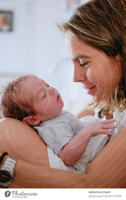 Happy mother holding newborn child happy woman baby care together love motherhood smile kid parent adorable childhood innocent infant little cute comfort