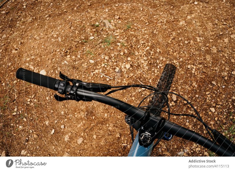 Bike on ground in countryside bicycle trip rough transport ride modern terrain route gear brown soil vehicle bike adventure equipment contemporary travel