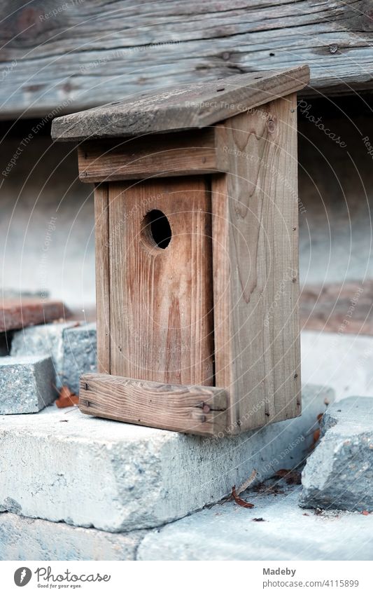Self-made nesting box or starling box with standardized flight hole made of beautiful wood on an old farm in Rudersau near Rottenbuch in the district Weilheim-Schongau in the Allgäu in Upper Bavaria