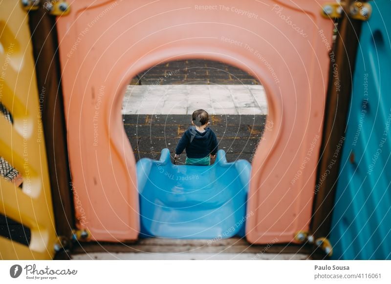 Rear view child playing in the playground Child 1 - 3 years Playground Slide Park Joy Toddler Day Colour photo Human being Infancy Exterior shot Playing