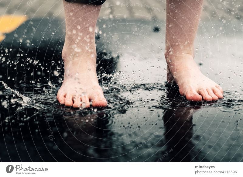 Jump barefoot into the puddle Wet Puddle Water Drops of water creative shutter speed fast shutter speed Asphalt Infancy Childhood memory Rain Playing Freedom