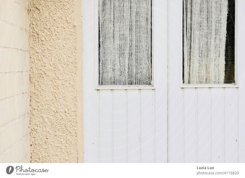 An old back door in soft colors, windows with curtains Back door Delicate Yellow Beige White Wood Wall (barrier) Curtain Deserted Exterior shot Old
